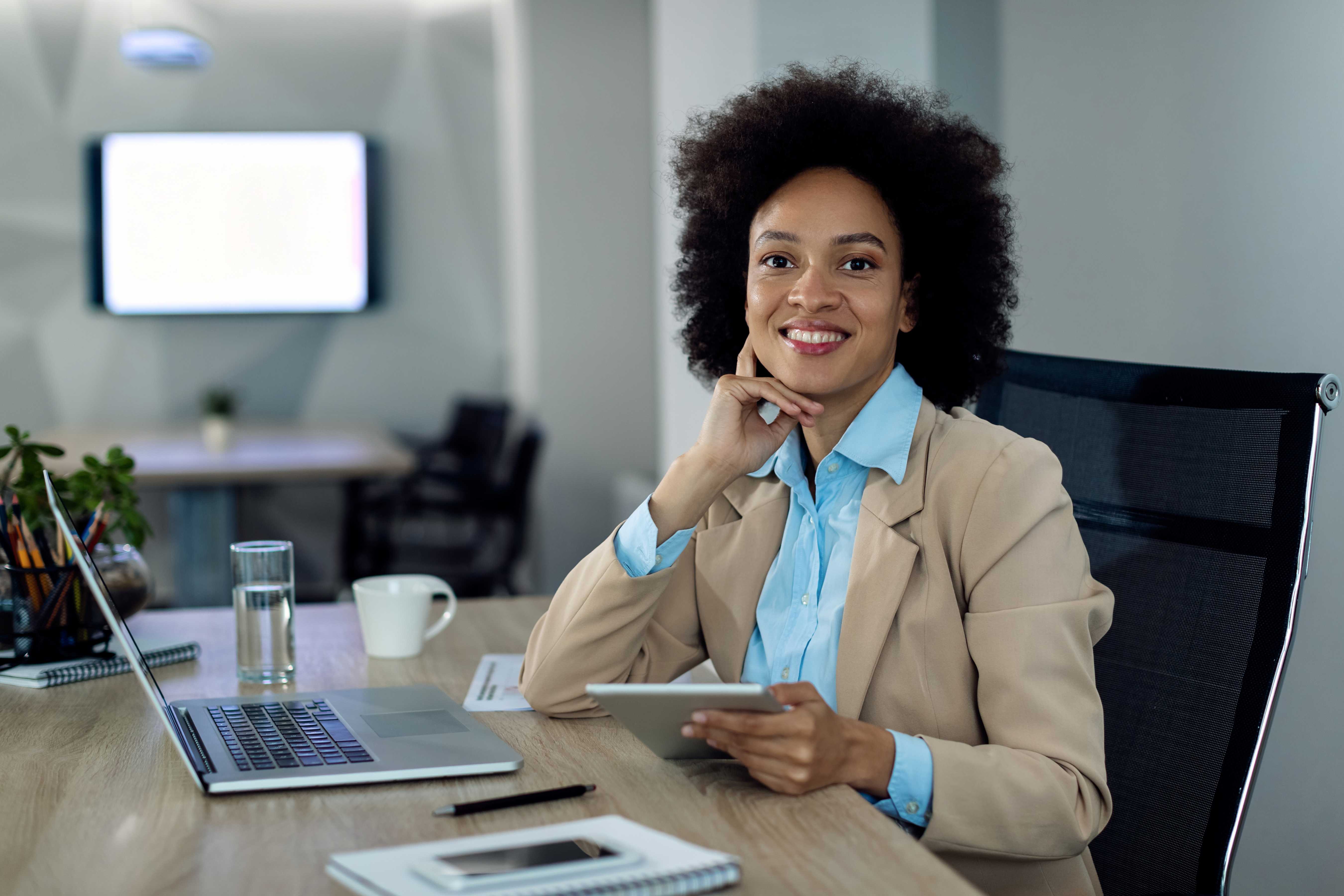 happy-african-american-businesswoman-working-touchpad-office-1